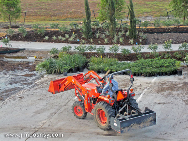 man on tractor landscaping a commercial landscape